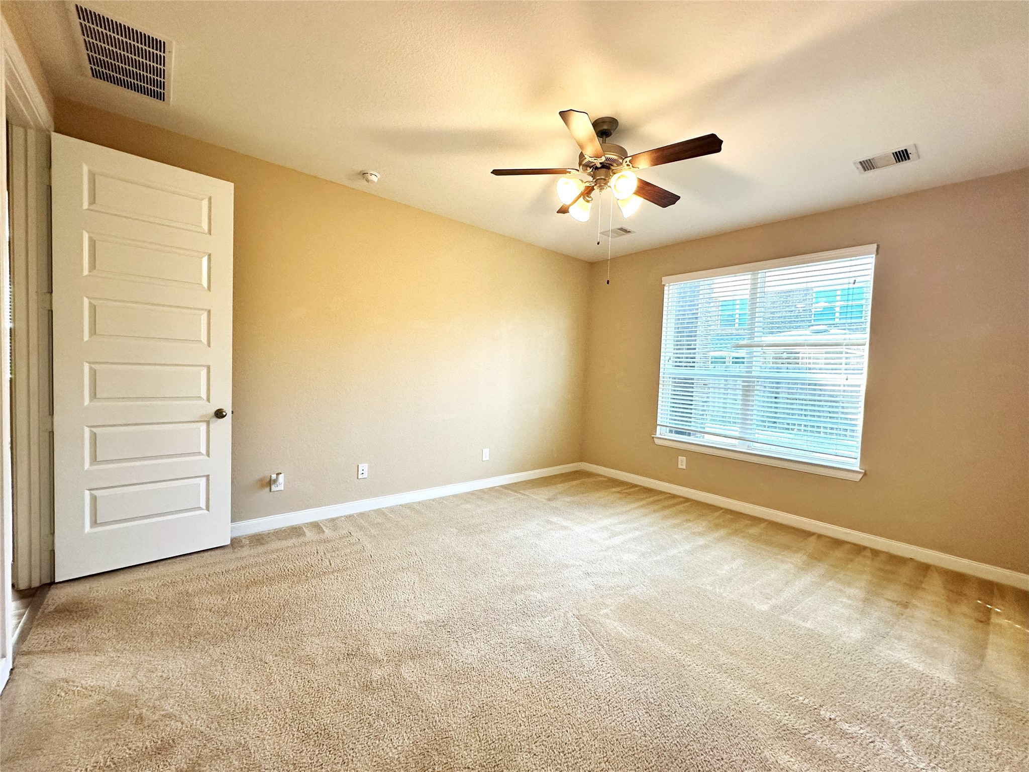 22523 Birch Ridge Meadow Drive Spring, TX 77389 - Photo 13 of 33 an empty room with windows and fan