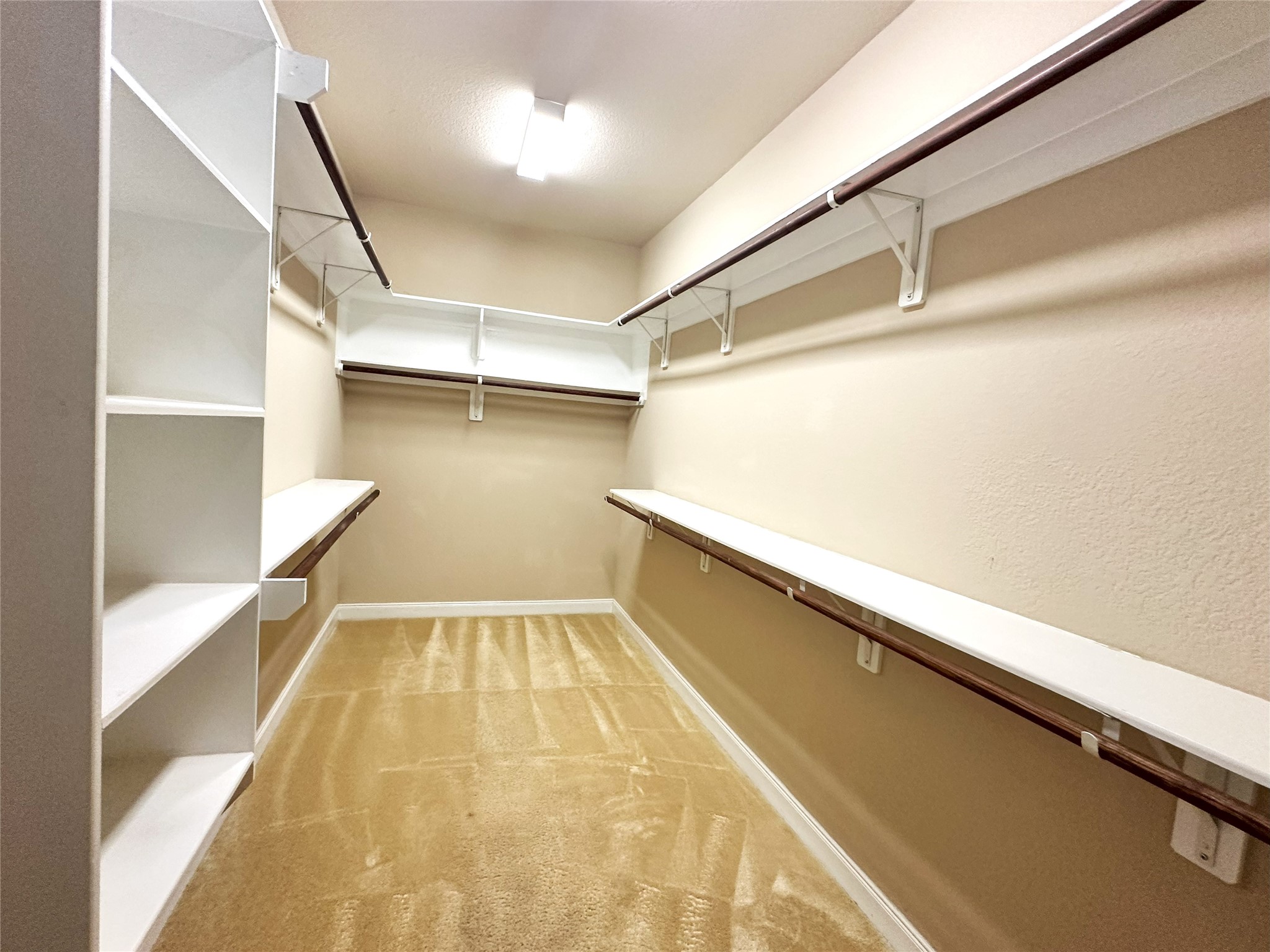 22523 Birch Ridge Meadow Drive Spring, TX 77389 - Photo 17 of 33 a view of walk in closet with empty racks
