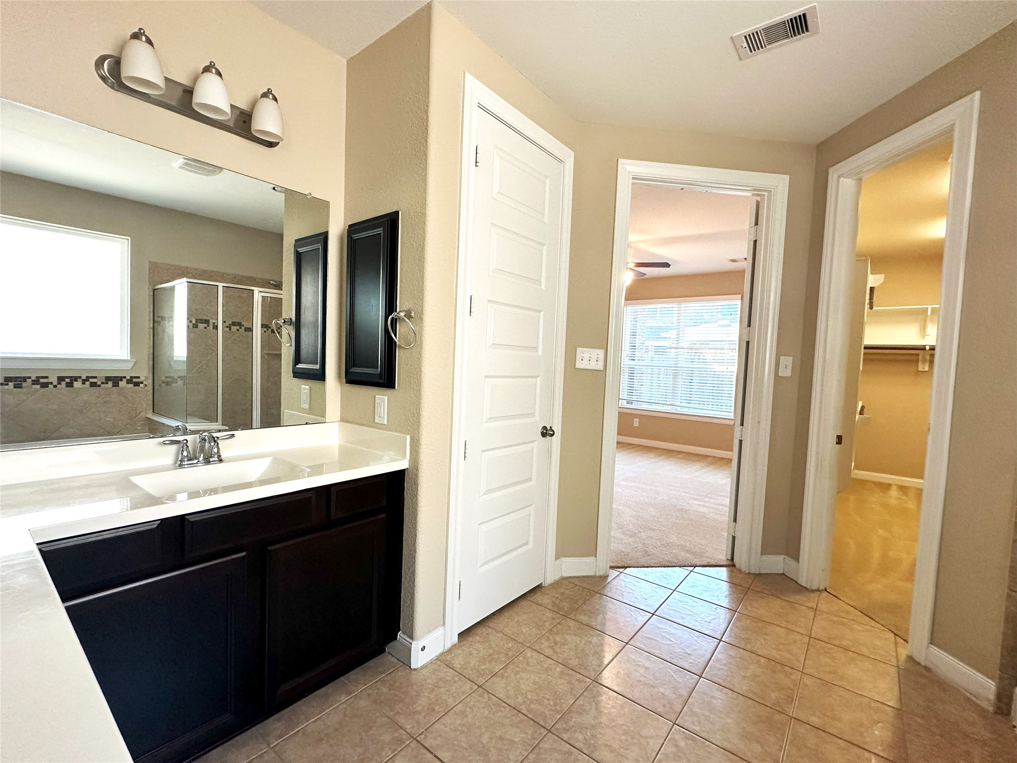 22523 Birch Ridge Meadow Drive Spring, TX 77389 - Photo 19 of 33 a bathroom with a double vanity sink a mirror and a shower