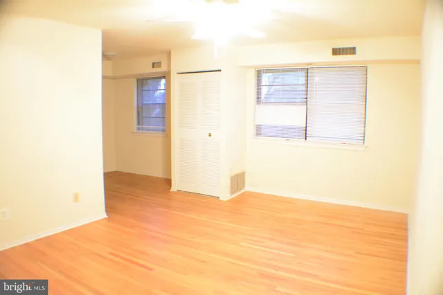 a view of an empty room with wooden floor