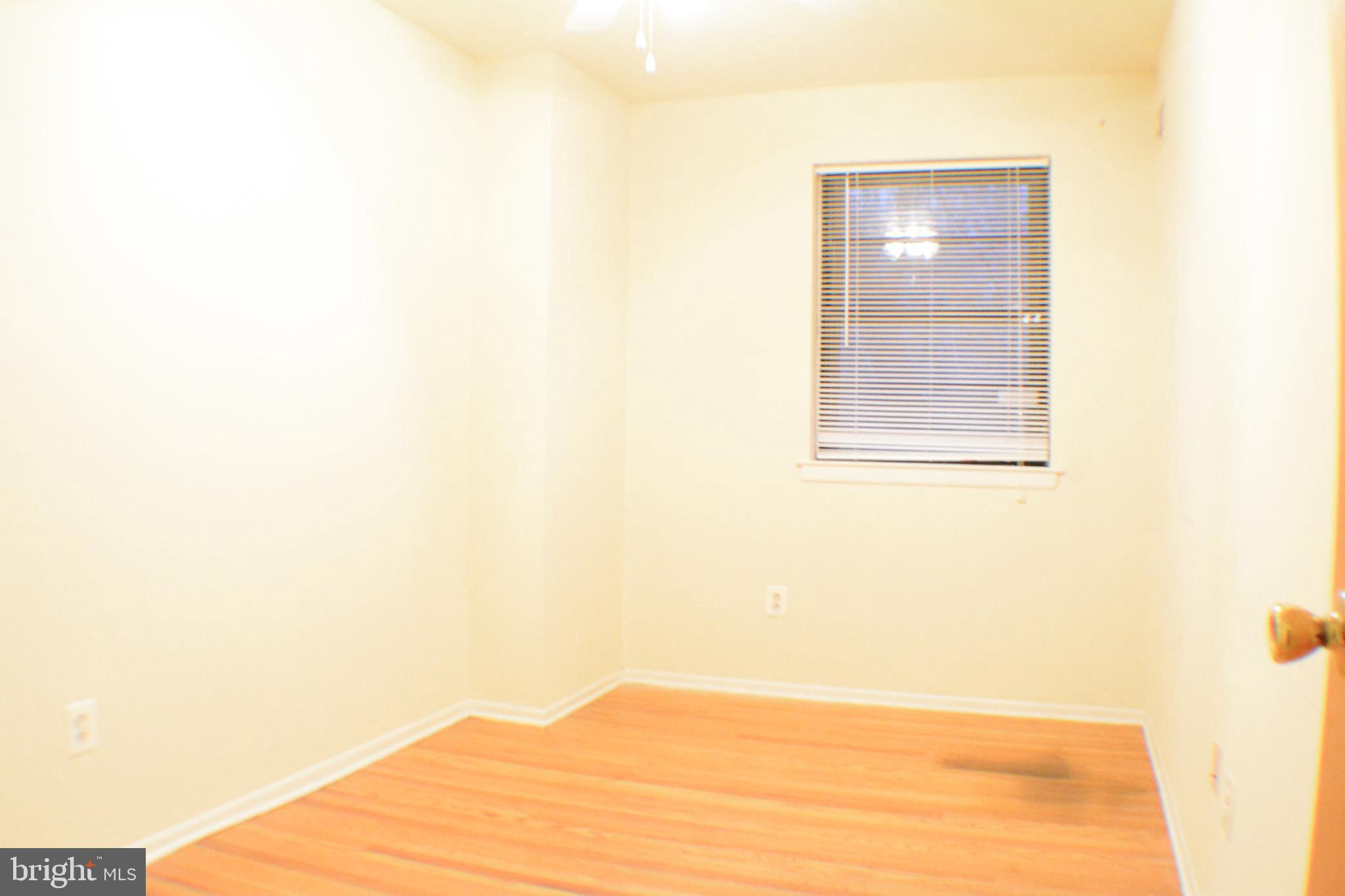 3411 Cresson Street, Unit 4 Philadelphia, PA 19129 - Photo 10 of 16 a view of an empty room with wooden floor and a window