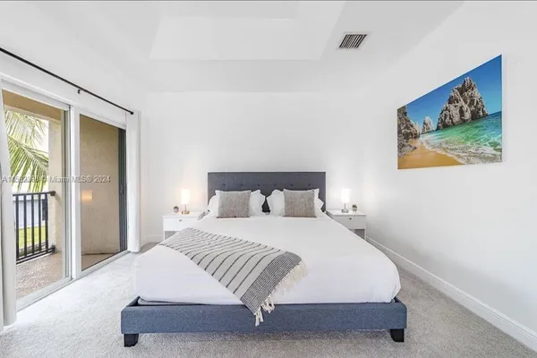 a bedroom with a bed and a painting on the wall