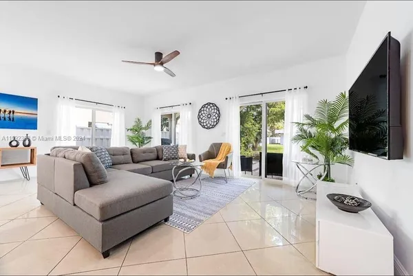 a living room with furniture and a flat screen tv