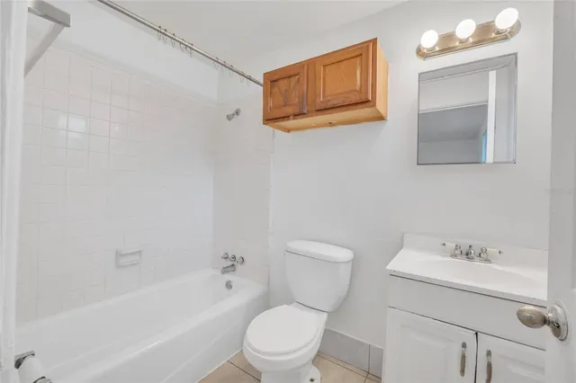 a white toilet sitting next to a bath tub