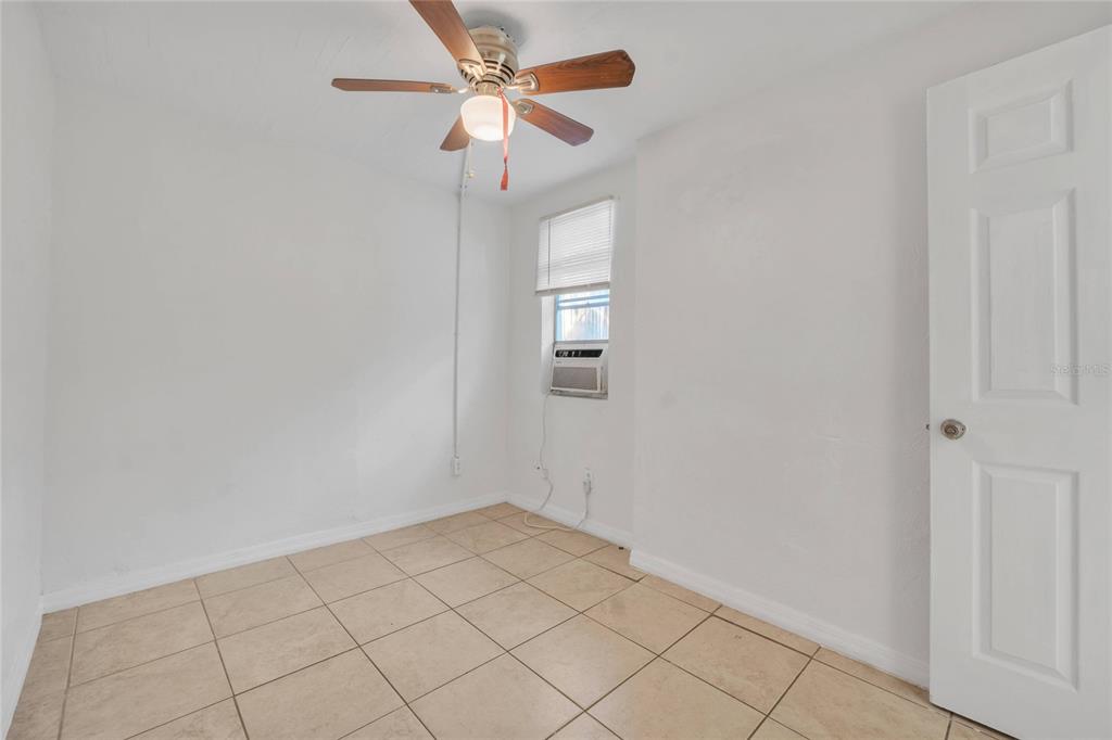 552 Fairmount Road Daytona Beach, FL 32114 - Photo 6 of 13 wooden floor in an empty room with a window