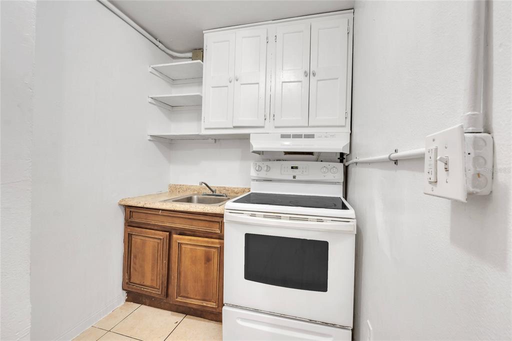 552 Fairmount Road Daytona Beach, FL 32114 - Photo 9 of 13 a view of washer and dryer with kitchen in the background