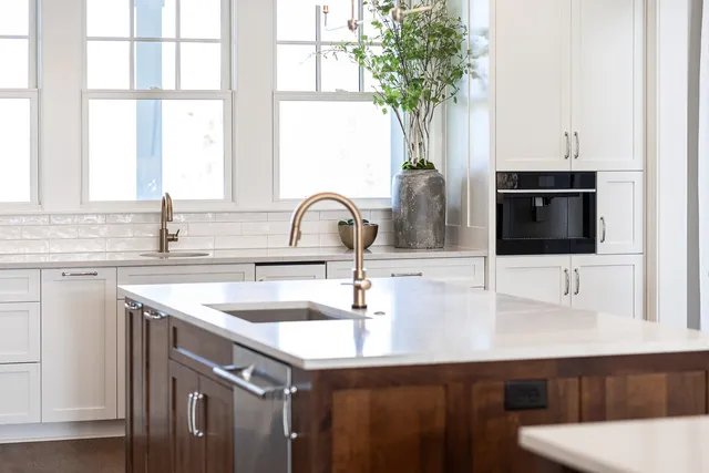 a white bath tub sitting in a bathroom next to a window