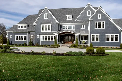 a living room with furniture a large window and wooden floor