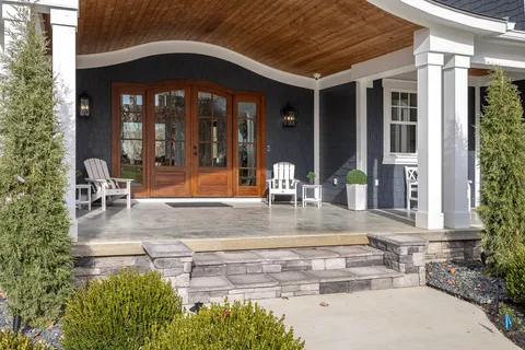 a living room with fireplace furniture and a large window