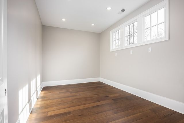 a view of a patio with couches table and chairs under an umbrella with a fire pit