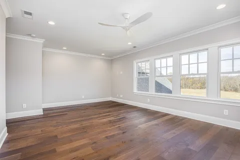 a aerial view of a house next to a yard