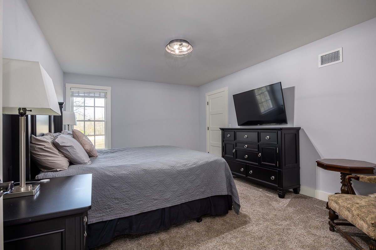 6876 Cross Keys Road College Grove, TN 37046 - Photo 81 of 99 a bedroom with a bed and a flat screen tv