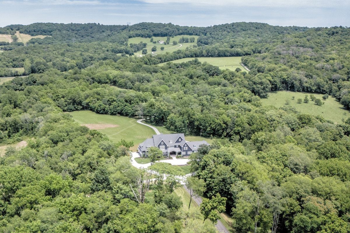 6876 Cross Keys Road College Grove, TN 37046 - Photo 97 of 99 a view of a lush green forest with trees and some houses
