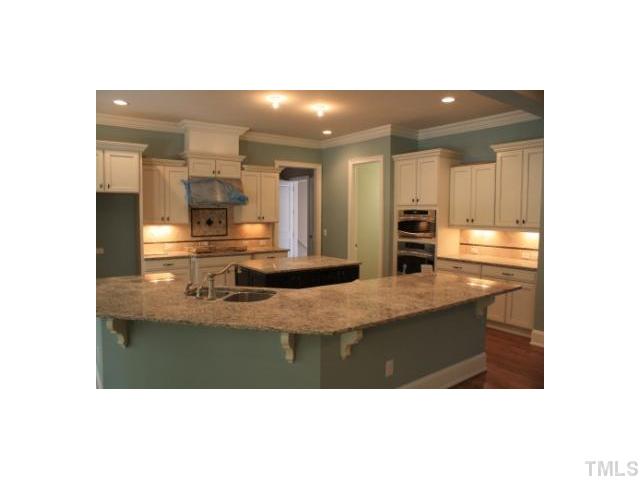 6817 Mactavish Way Raleigh, NC 27613 - Photo 4 of 25 a bathroom with a sink and a large mirror