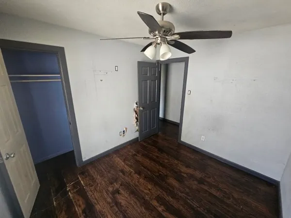 a view of an empty room with wooden floor
