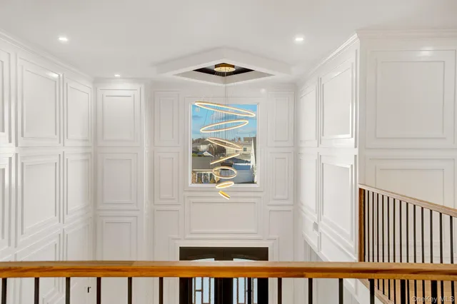 a view of a hallway with wooden floor and entryway