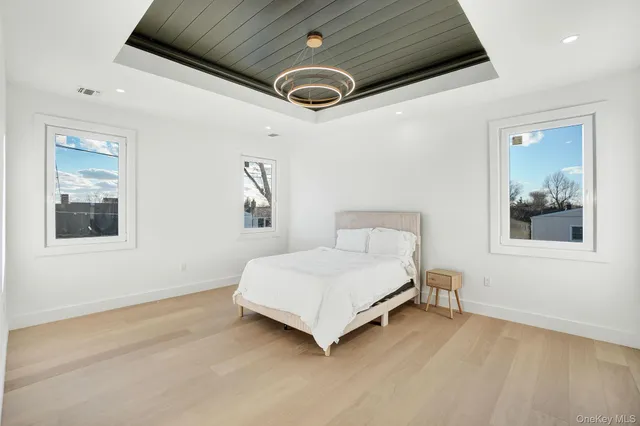 a spacious bedroom with a bed and a window