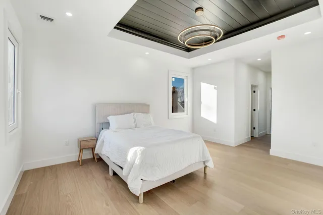 a spacious bedroom with a bed and a ceiling fan