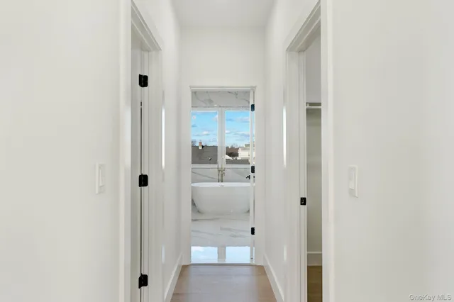 a view of a hallway with a livingroom and a bathroom sink
