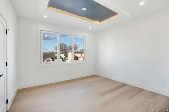 an empty room with window and ceiling fan