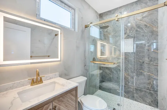 a bathroom with a sink toilet and shower