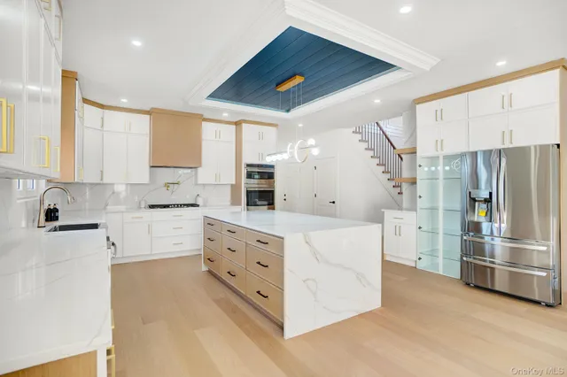 a kitchen with white cabinets and stainless steel appliances