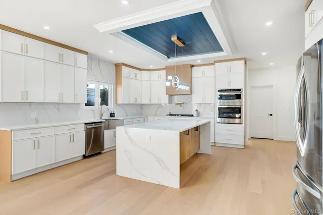 a kitchen with granite countertop white cabinets and white appliances