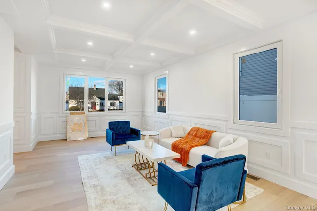 a living room with furniture and kitchen view