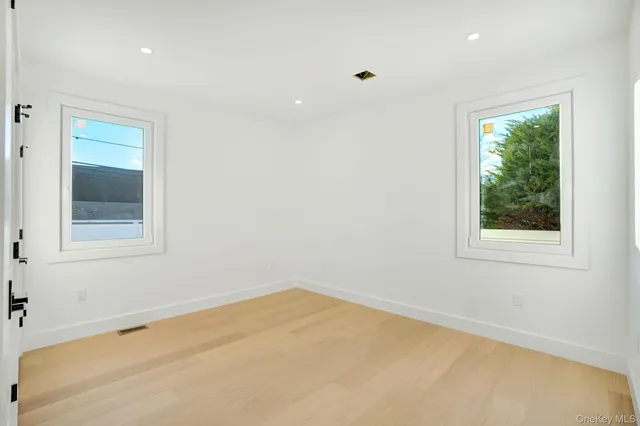 a view of a room with a window and a ceiling fan