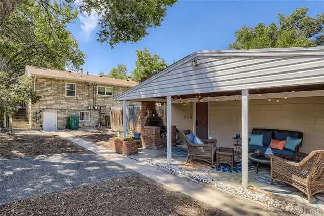 a view of a house with backyard porch and sitting area