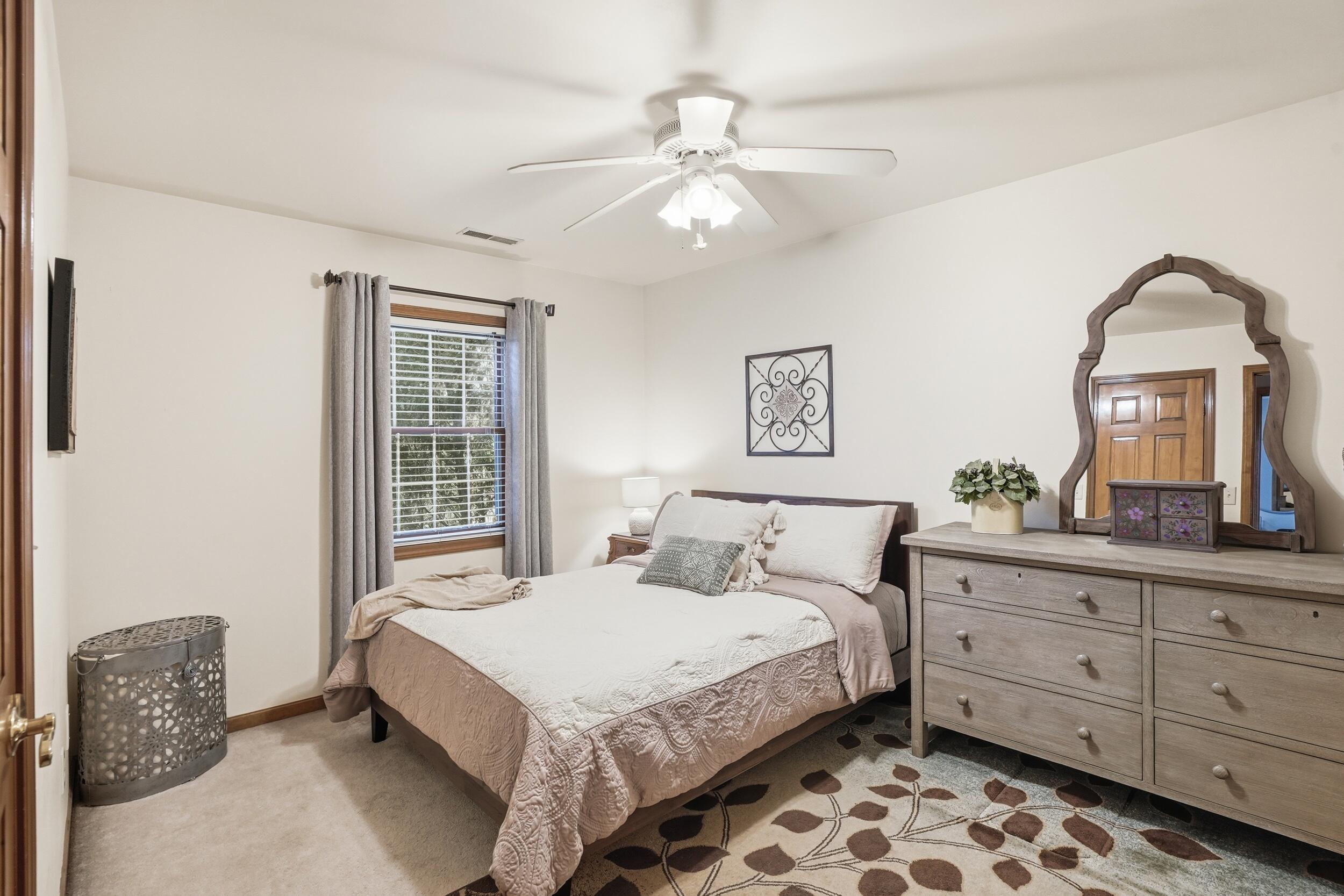 11063 Marion Place Crown Point, IN 46307 - Photo 14 of 22 a bedroom with a bed and a chandelier