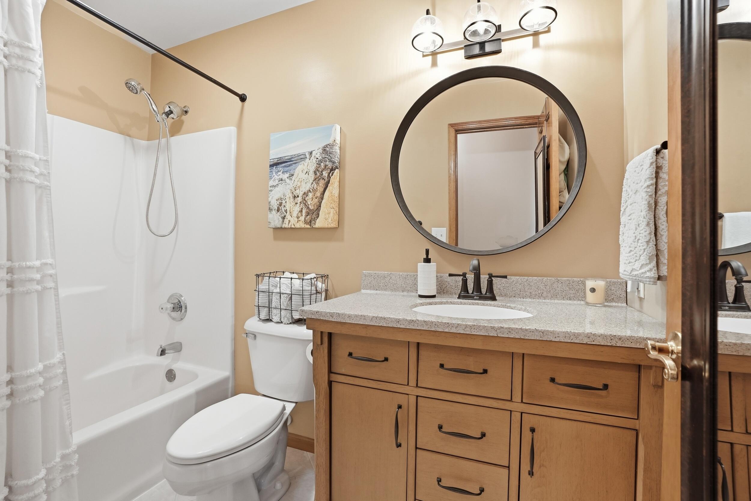 11063 Marion Place Crown Point, IN 46307 - Photo 16 of 22 a bathroom with a granite countertop sink a toilet and a mirror