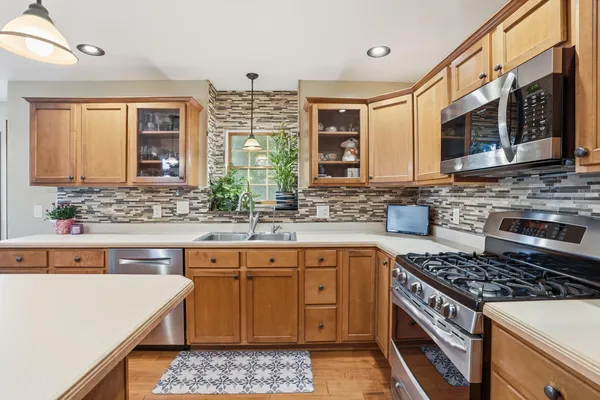 a kitchen with stainless steel appliances granite countertop a stove and a sink
