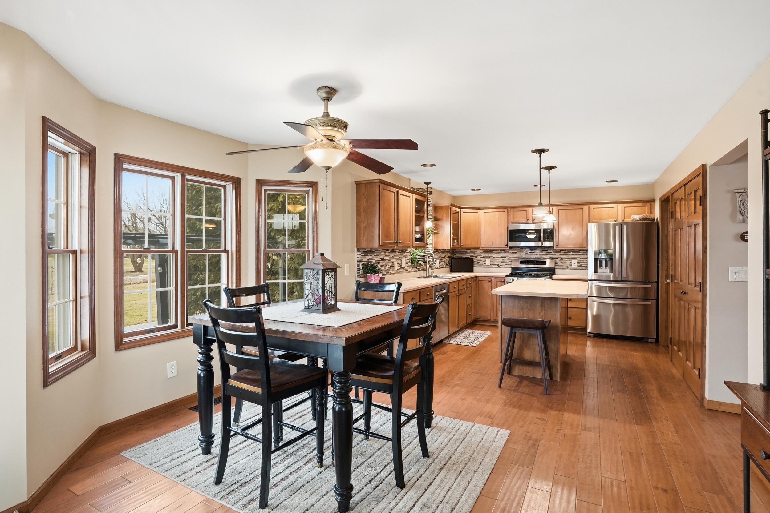 11063 Marion Place Crown Point, IN 46307 - Photo 5 of 22 a view of a dining room with furniture window and wooden floor