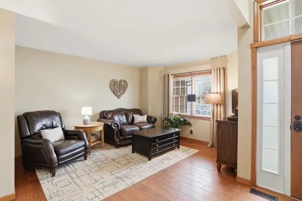a living room with furniture rug and wooden floor