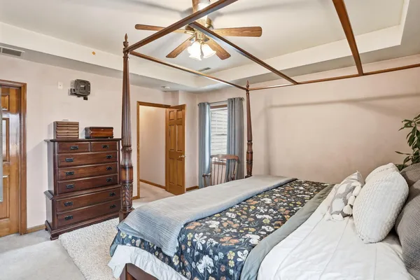 a bedroom with a bed and a mirror