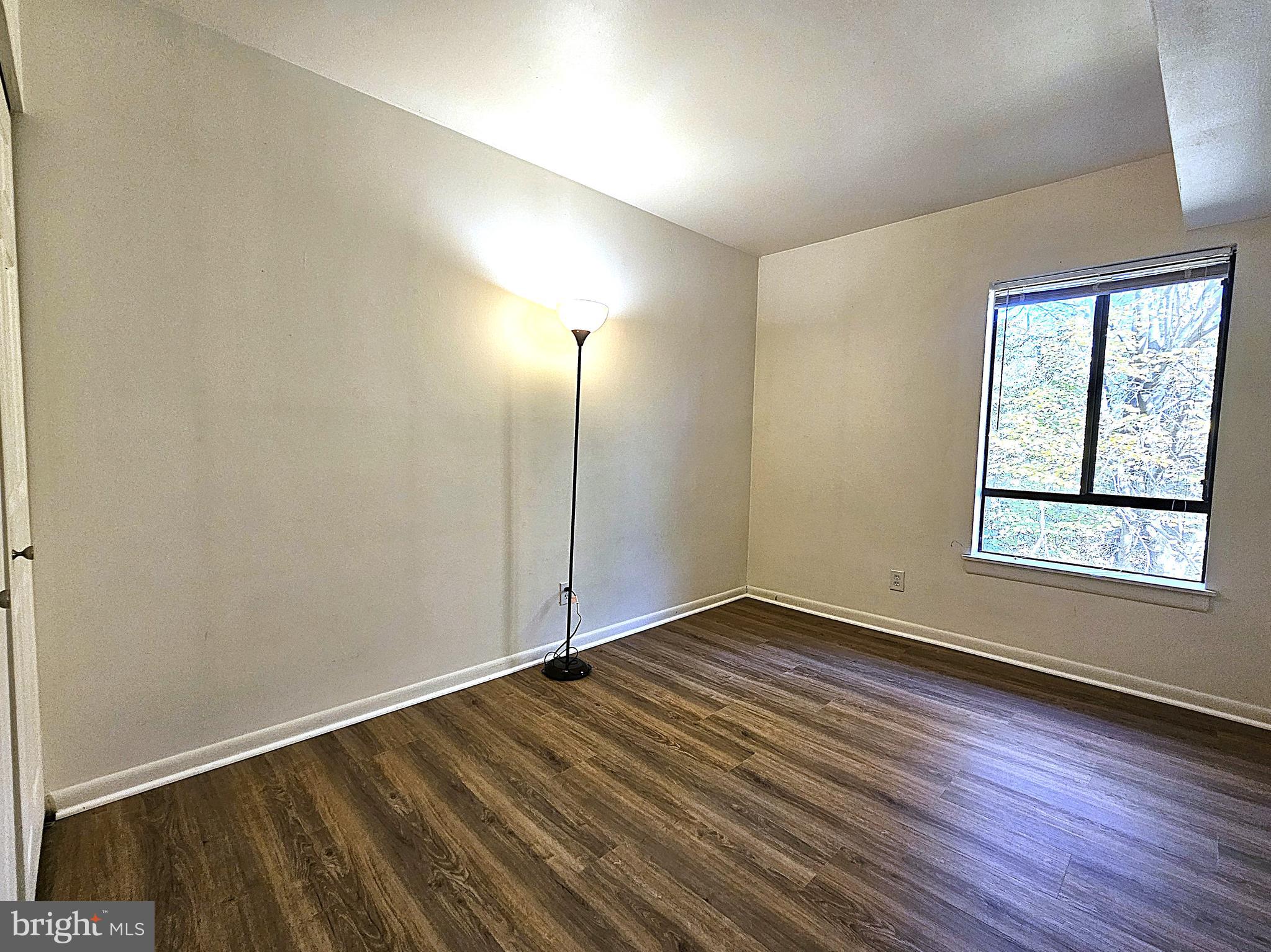 2239 Castle Rock Square, Unit 21C Reston, VA 20191 - Photo 12 of 30 an empty room with wooden floor and windows