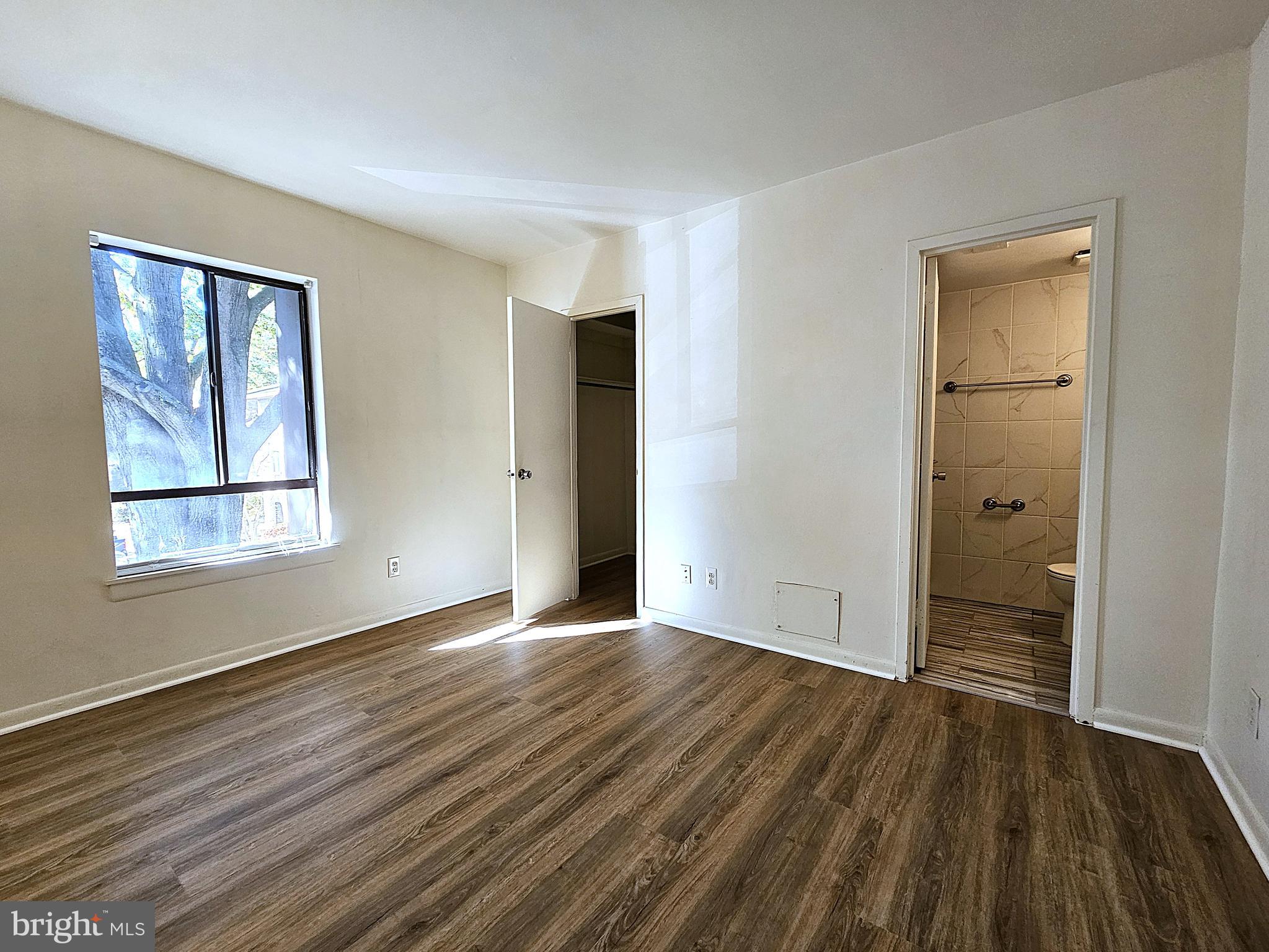 2239 Castle Rock Square, Unit 21C Reston, VA 20191 - Photo 17 of 30 wooden floor in an empty room with a window