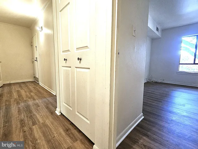 a view of hallway with wooden floor