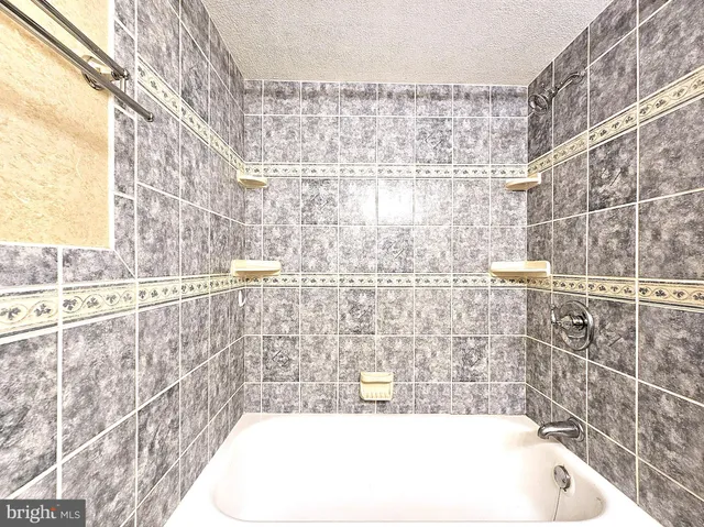 a bathroom with a bathtub and shower