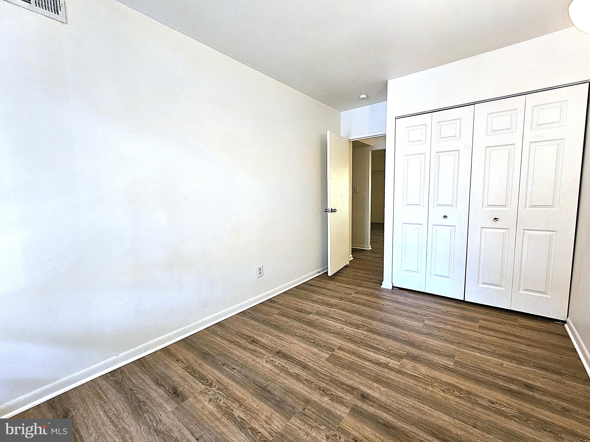 2239 Castle Rock Square, Unit 21C Reston, VA 20191 - Photo 24 of 30 a view of an empty room with wooden floor