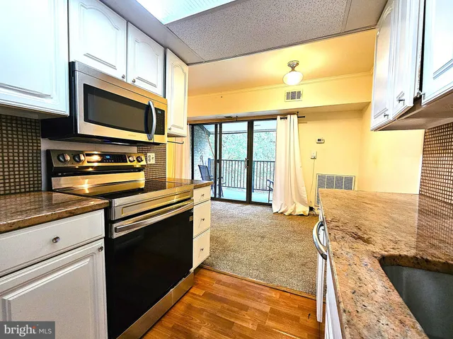 a kitchen with a stove a sink and a microwave