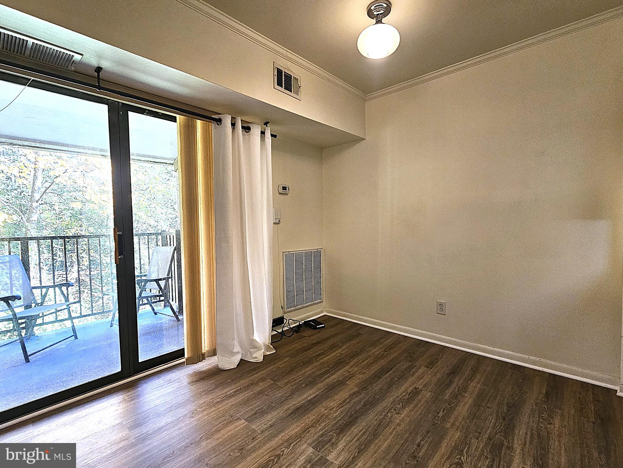 2239 Castle Rock Square, Unit 21C Reston, VA 20191 - Photo 5 of 30 an empty room with wooden floor and windows