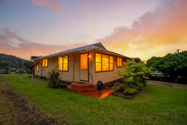a backyard of a house with wooden fence table and chairs
