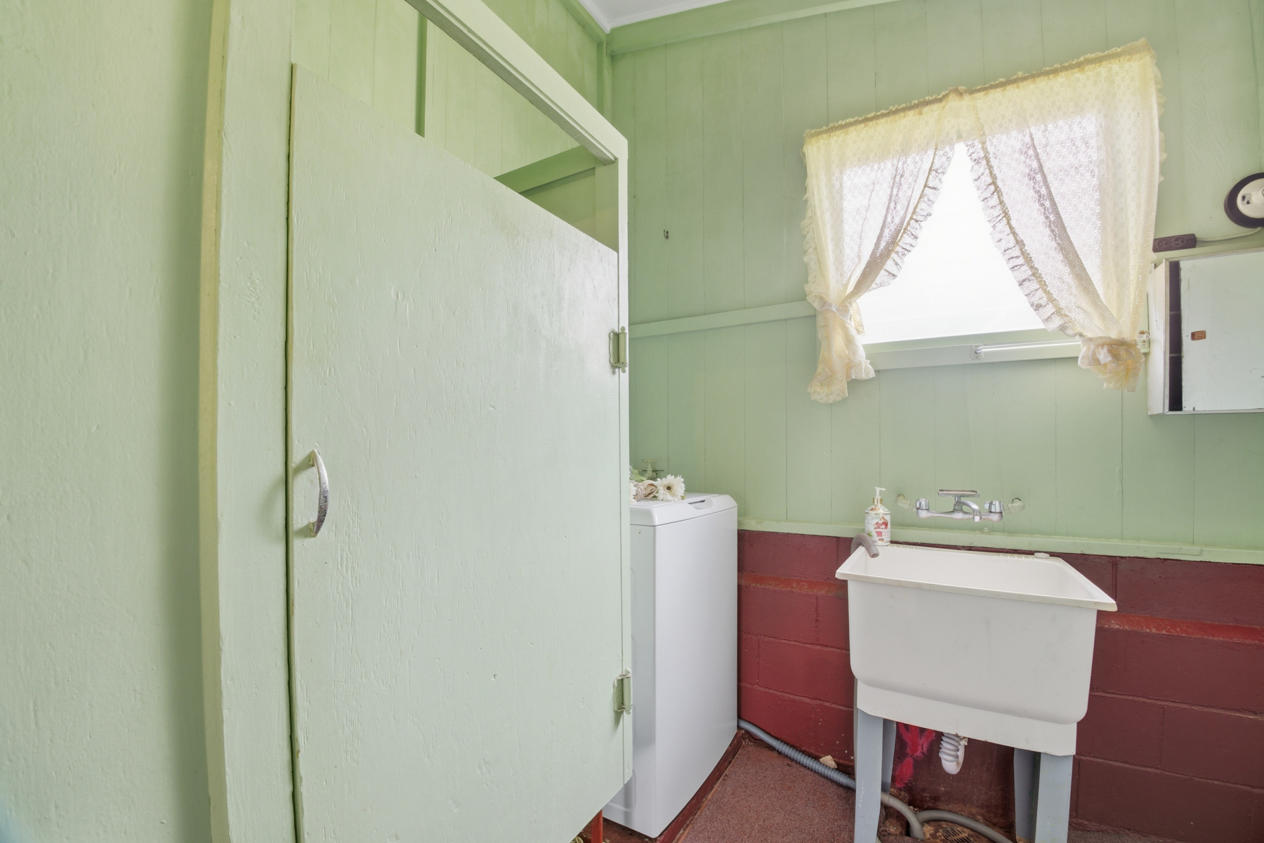 4069 Koloa Road Koloa, HI 96756 - Photo 15 of 23 a bathroom with a sink a mirror and a window