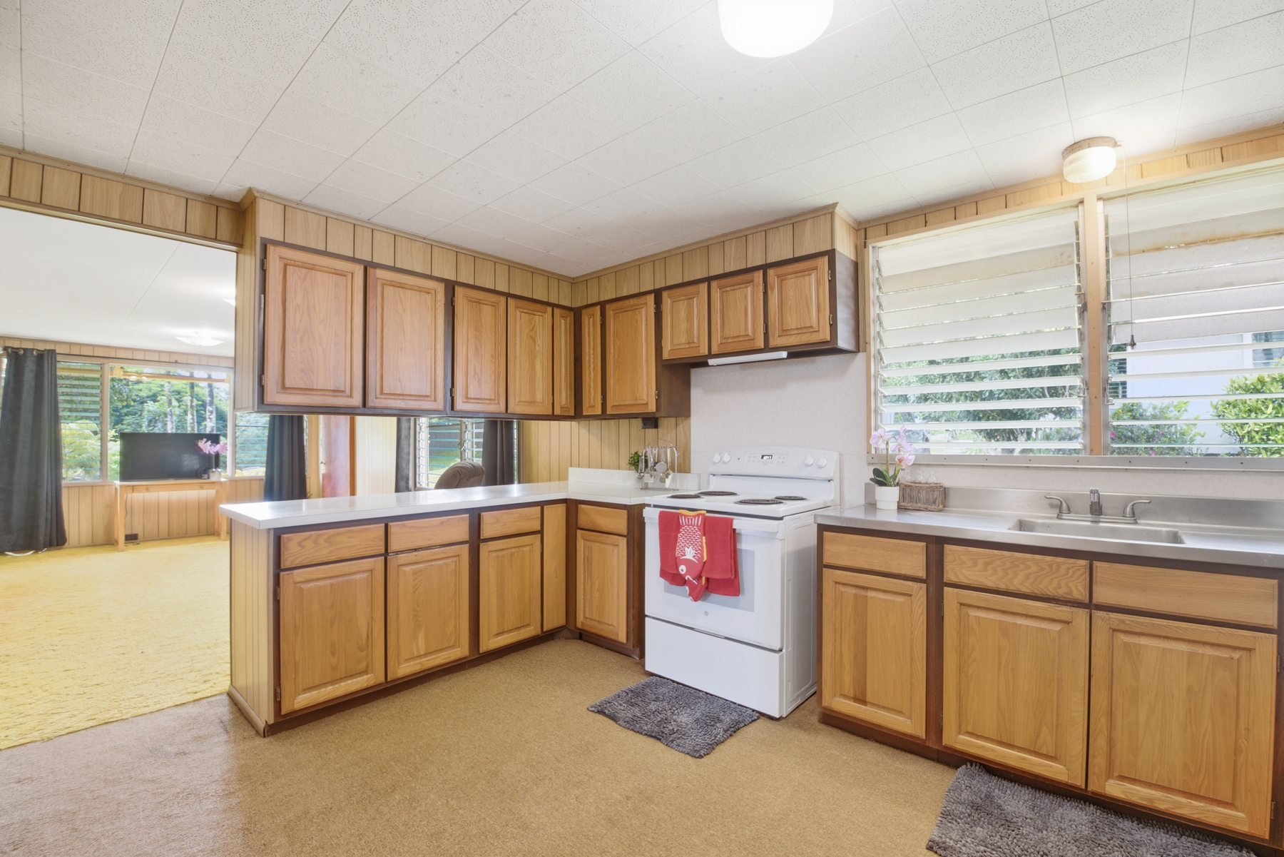 4069 Koloa Road Koloa, HI 96756 - Photo 5 of 23 a kitchen with sink cabinets and window