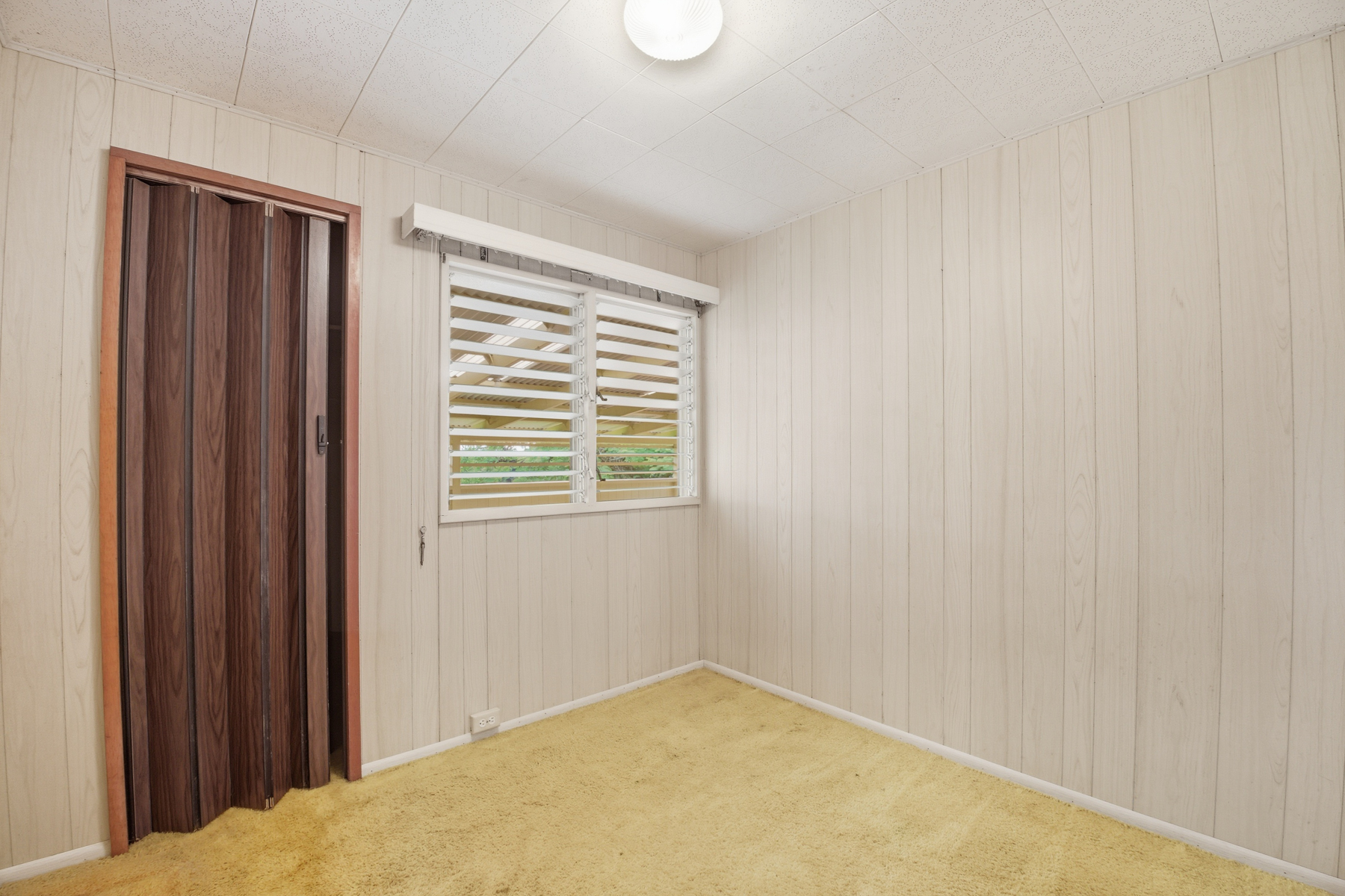 4069 Koloa Road Koloa, HI 96756 - Photo 8 of 23 a view of an empty room with wooden floor and a window