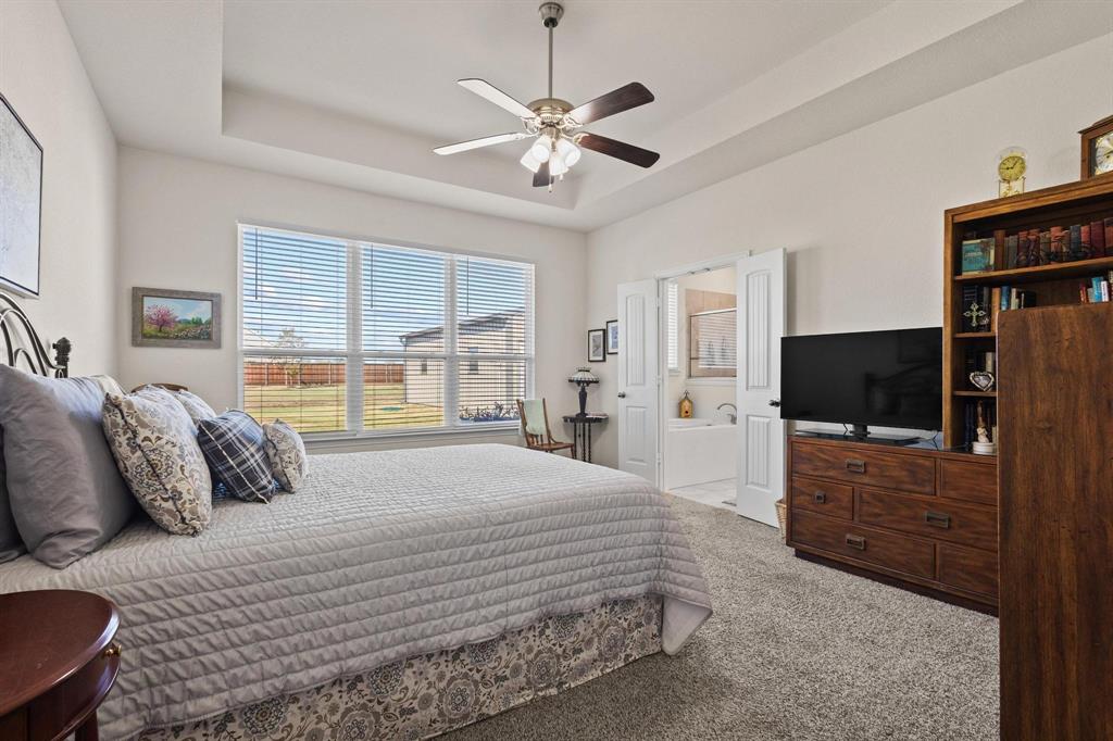 1875 Whitemound Road Sherman, TX 75090 - Photo 18 of 40 a bedroom with a bed and a flat screen tv
