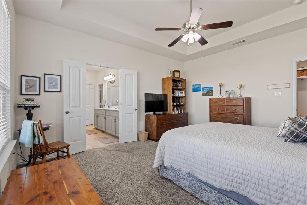 1875 Whitemound Road Sherman, TX 75090 - Photo 20 of 40 a bedroom with a bed and a chandelier