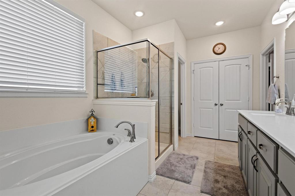 1875 Whitemound Road Sherman, TX 75090 - Photo 22 of 40 a bathroom with a bathtub a sink a vanity and a shower